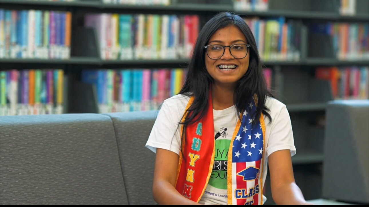 A scholar wearing her Guyana-colored academy stole