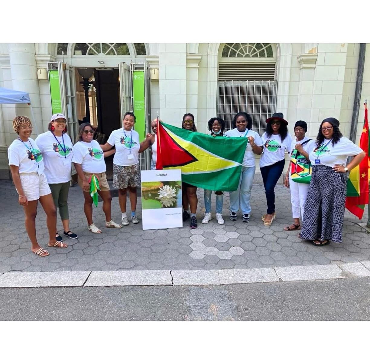Proudly holding the Guyana flag with the foundation team