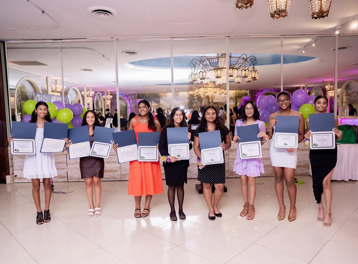 Scholars holding certificates at the scholarship luncheon
