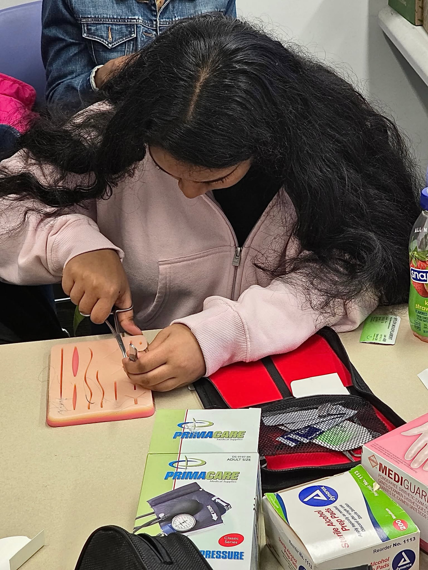Practicing suturing on a training pad