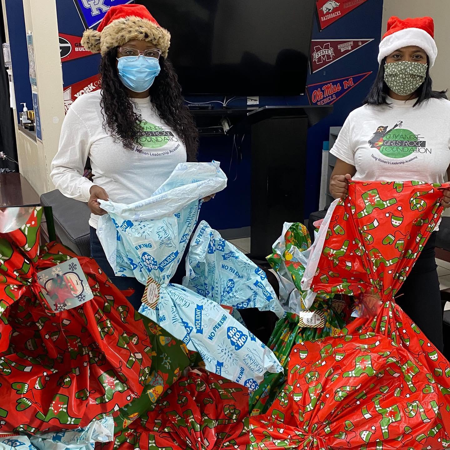 Volunteers with wrapped holiday gifts