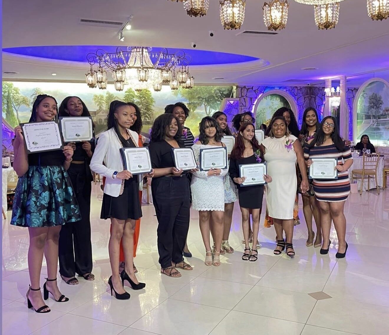Scholars holding certificates at the scholarship luncheon