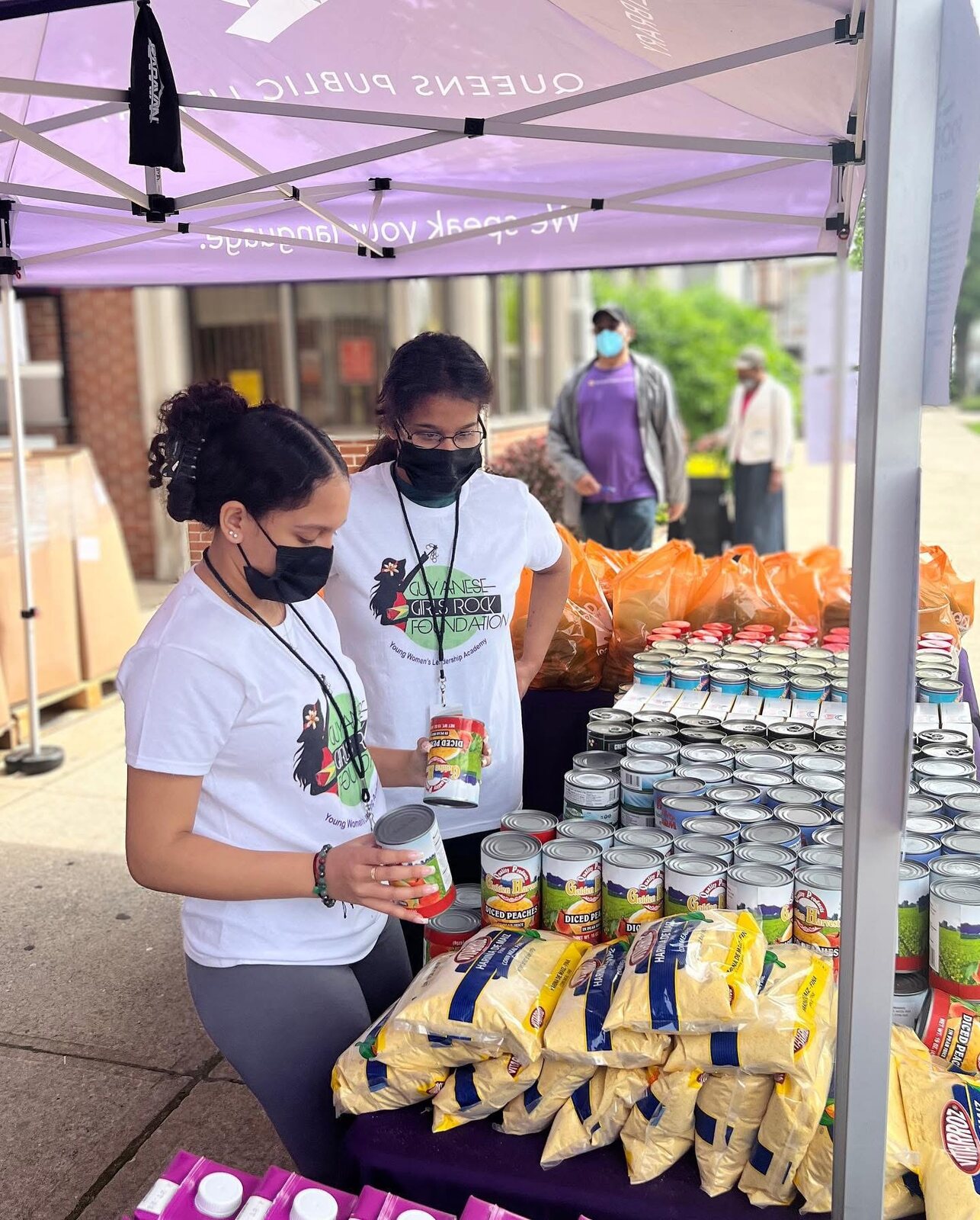 Sorting donations under the Queens Public Library tent