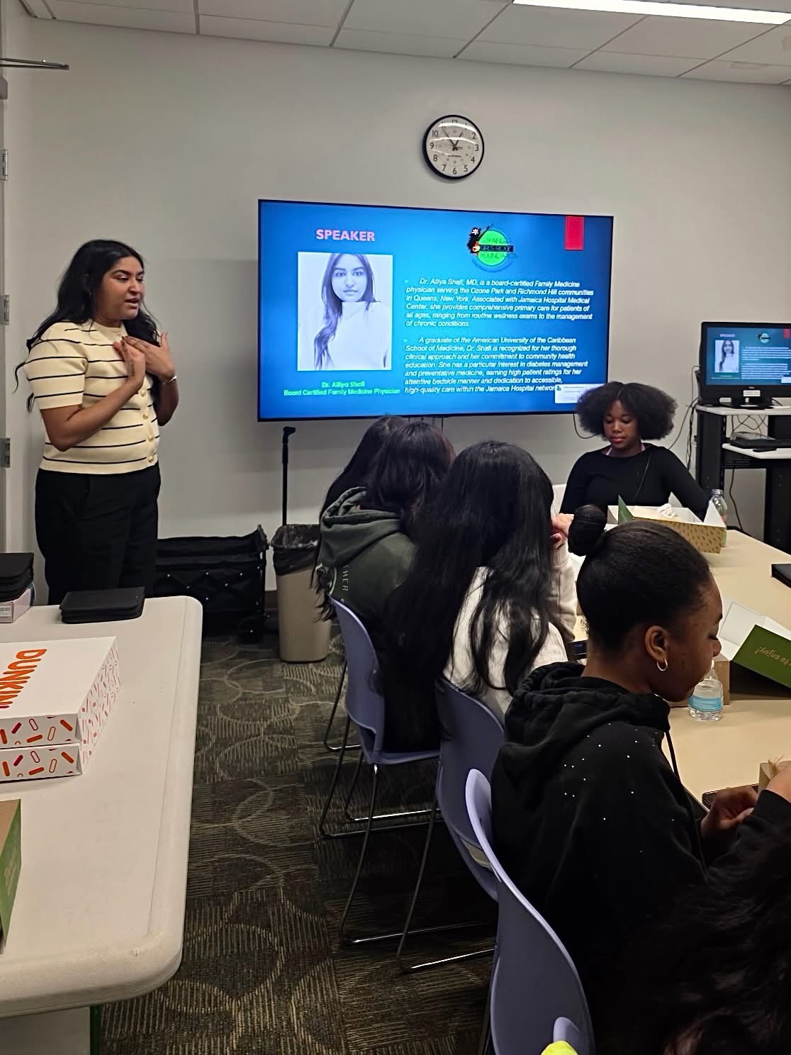 A guest physician speaks with scholars in the classroom